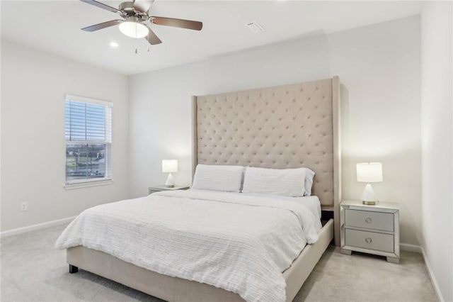 bedroom featuring ceiling fan and light carpet