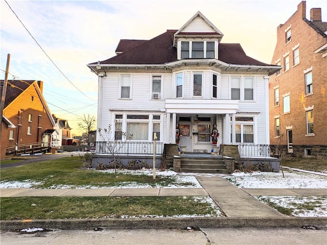 victorian home with a yard