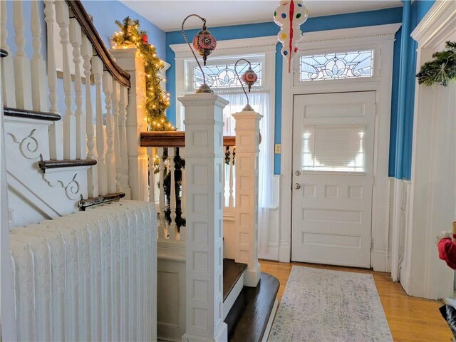 entrance foyer with wood-type flooring and radiator heating unit