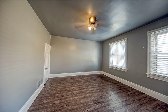 unfurnished room featuring dark hardwood / wood-style floors and ceiling fan