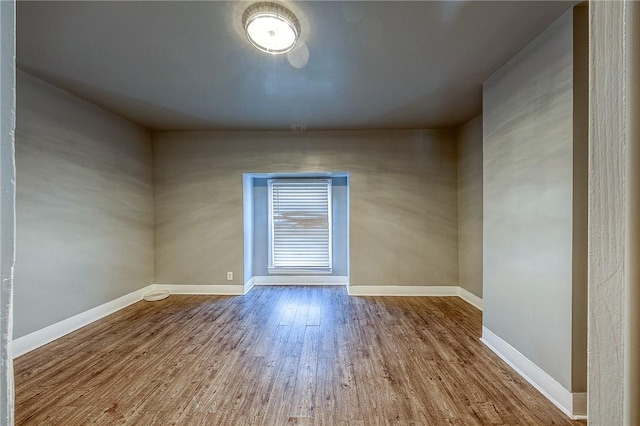 spare room with wood-type flooring