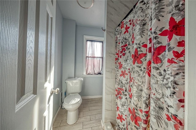 bathroom with toilet and walk in shower