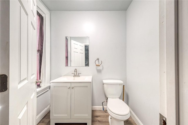 bathroom featuring vanity, toilet, and wood-type flooring