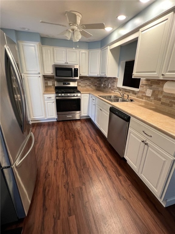 kitchen with white cabinetry, sink, dark hardwood / wood-style floors, and appliances with stainless steel finishes