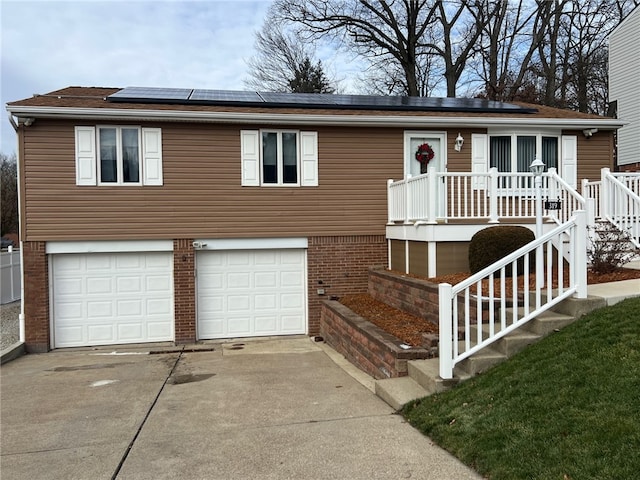 view of front of home with solar panels and a garage