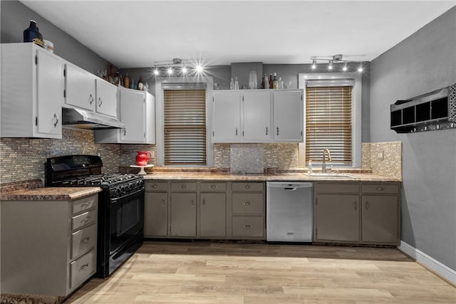 kitchen with sink, stainless steel dishwasher, black range with gas cooktop, gray cabinets, and light wood-type flooring