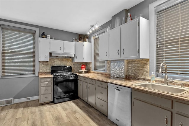 kitchen with black range with gas stovetop, white cabinetry, sink, and stainless steel dishwasher