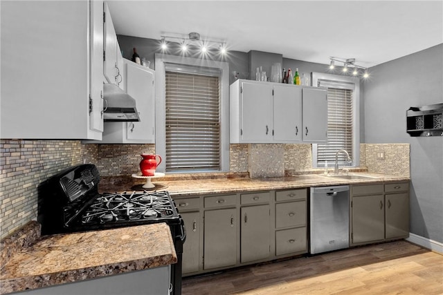 kitchen featuring gray cabinetry, dishwasher, sink, black gas range oven, and light hardwood / wood-style floors