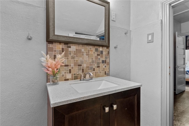 bathroom with backsplash and vanity