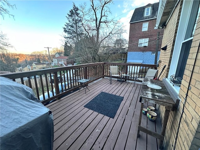 deck at dusk with a grill