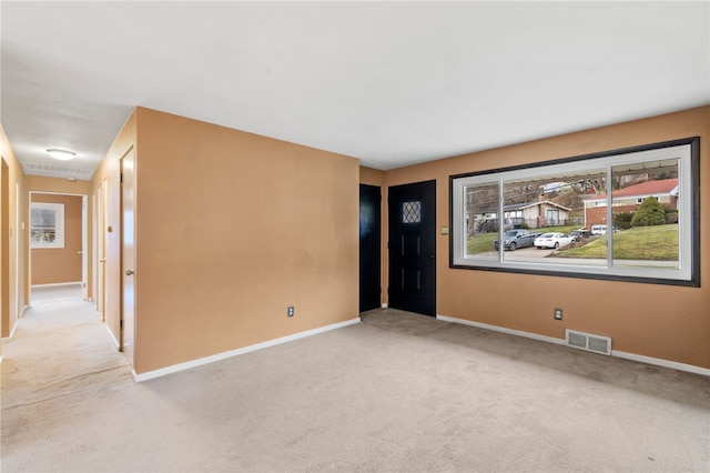 unfurnished room with light carpet