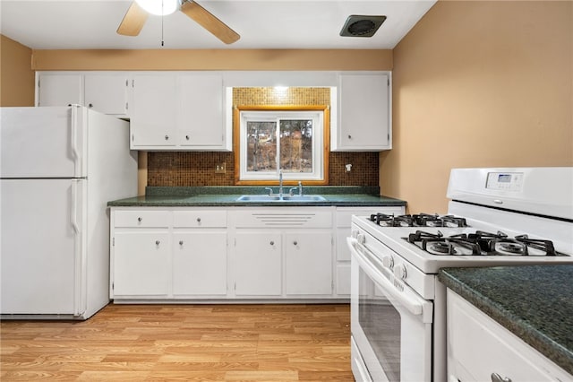 kitchen with white appliances, backsplash, white cabinets, sink, and light hardwood / wood-style flooring