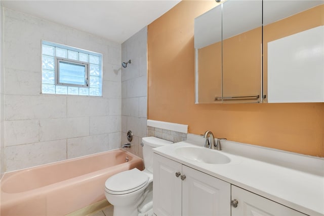 full bathroom featuring tile patterned flooring, vanity, tiled shower / bath combo, and toilet