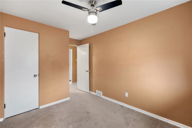 unfurnished bedroom with ceiling fan and light colored carpet