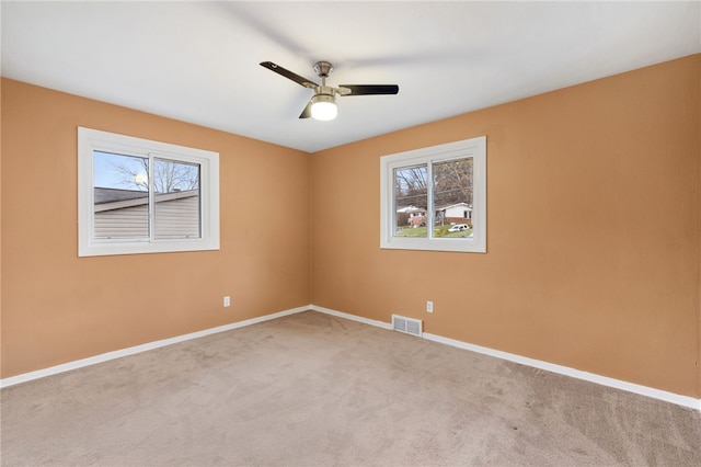 unfurnished room featuring ceiling fan and carpet