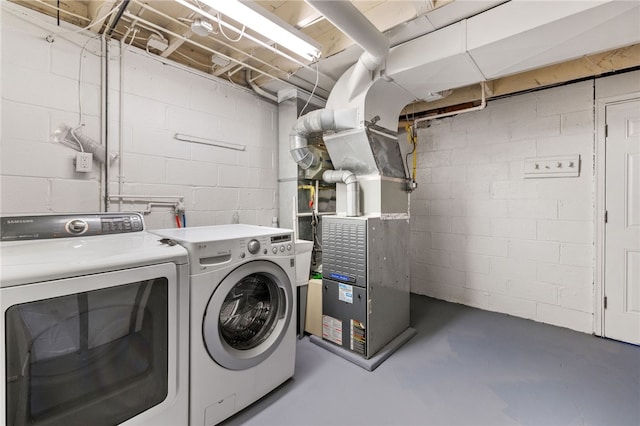 washroom with separate washer and dryer and heating unit