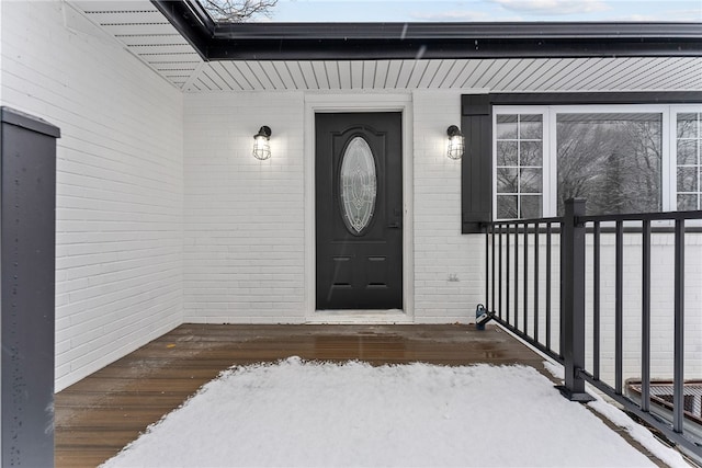 view of snow covered property entrance