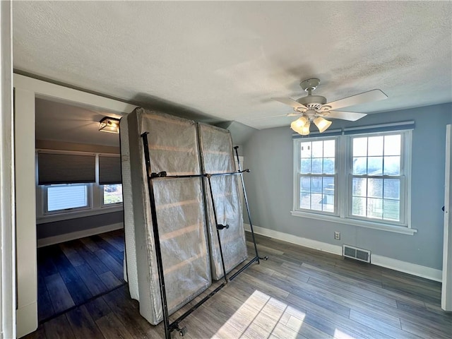 bathroom featuring a textured ceiling, ceiling fan, vaulted ceiling, and hardwood / wood-style flooring