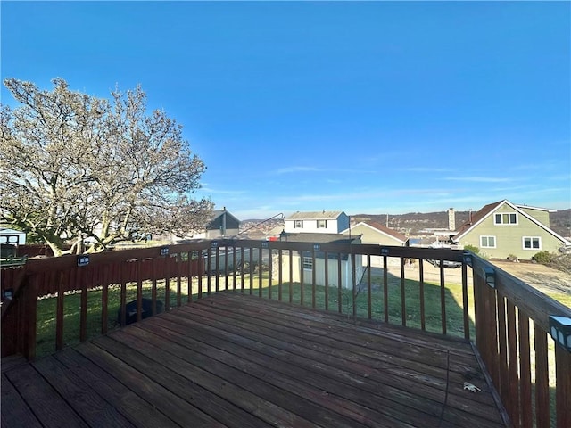 wooden deck featuring a lawn