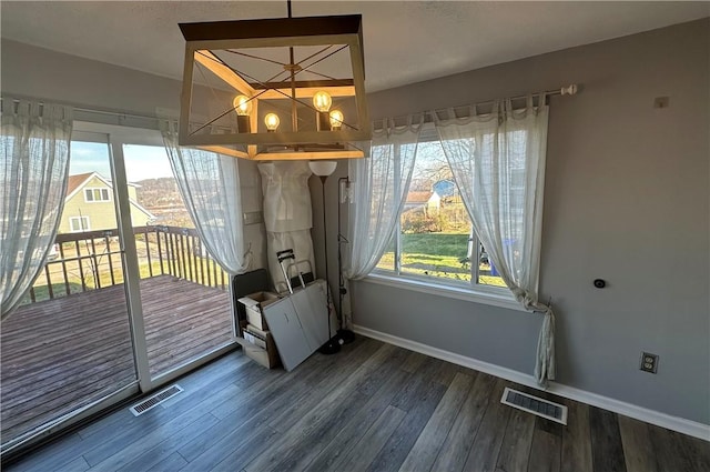 unfurnished dining area featuring plenty of natural light and dark hardwood / wood-style floors