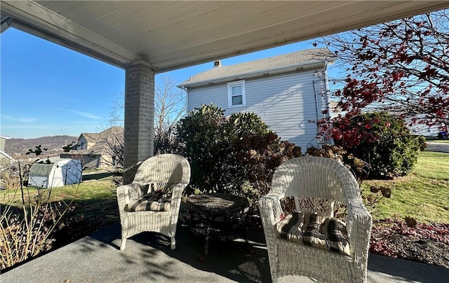 view of patio featuring a storage shed