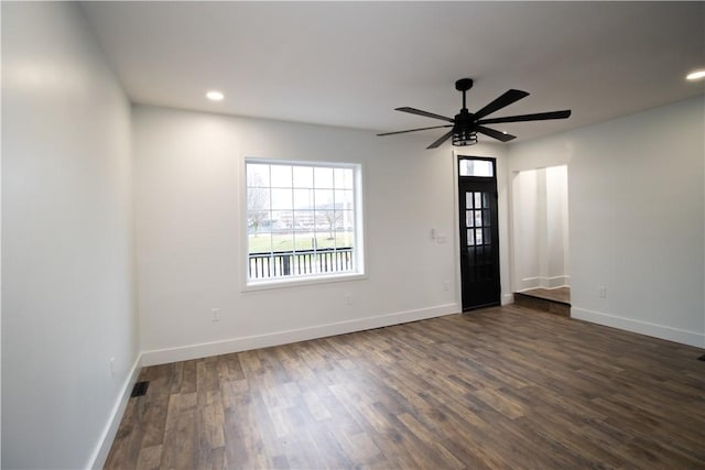 spare room with ceiling fan and dark hardwood / wood-style flooring