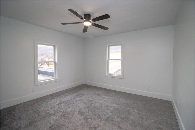 unfurnished room with carpet flooring, ceiling fan, and a healthy amount of sunlight