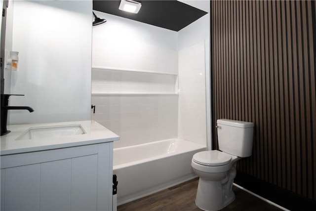 full bathroom with vanity, hardwood / wood-style flooring, bathtub / shower combination, and toilet