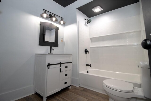 full bathroom featuring vanity, wood-type flooring,  shower combination, and toilet