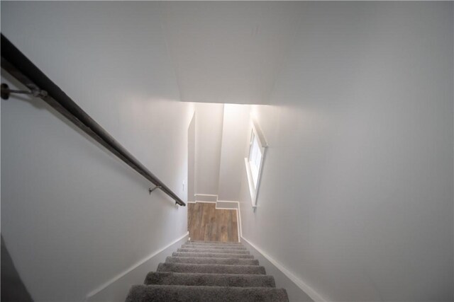 stairs featuring hardwood / wood-style floors