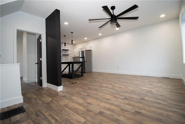 living room featuring ceiling fan, dark wood-type flooring, and vaulted ceiling