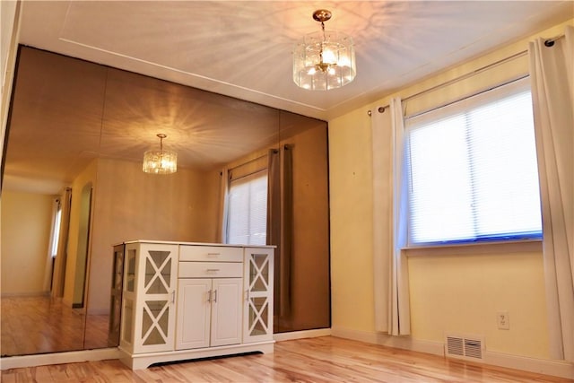 interior space with hardwood / wood-style floors and a chandelier