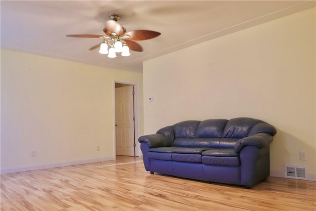 living room with ceiling fan and light wood-type flooring