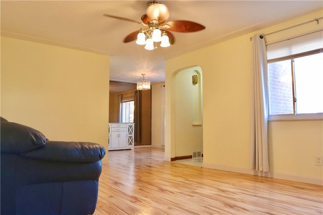 living room with light wood-type flooring and ceiling fan