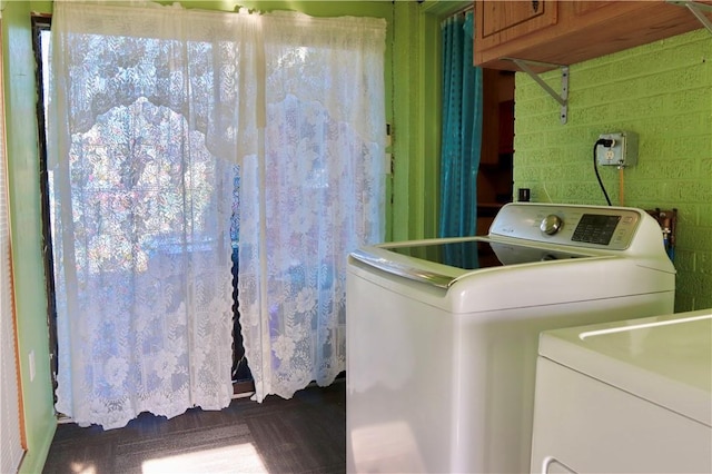 clothes washing area featuring cabinets and independent washer and dryer