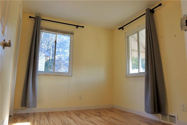 spare room with light hardwood / wood-style flooring