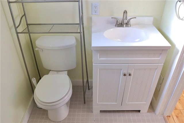 bathroom with tile patterned flooring, vanity, and toilet