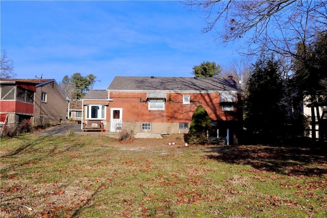 back of property featuring a yard