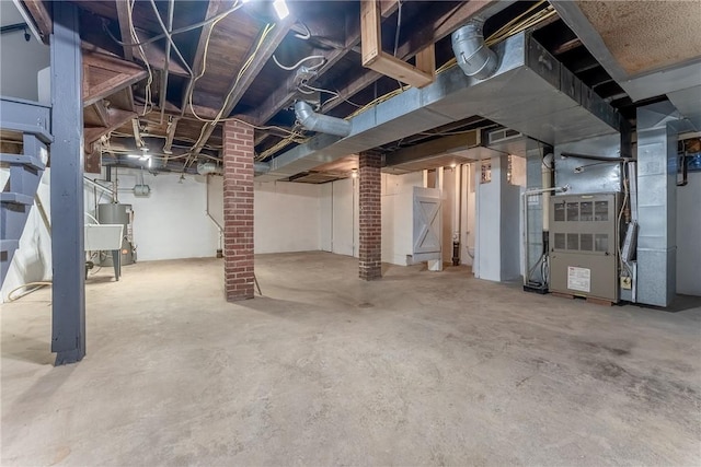 basement featuring heating unit and water heater