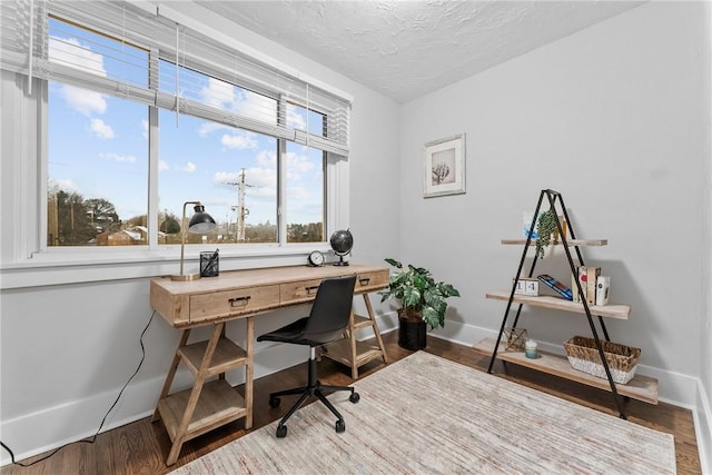 home office featuring hardwood / wood-style floors and a textured ceiling