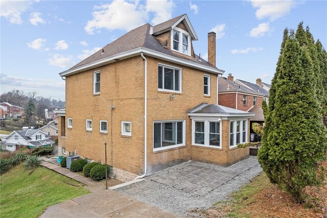 view of home's exterior with a patio and central air condition unit