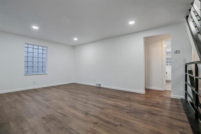 empty room with dark hardwood / wood-style flooring