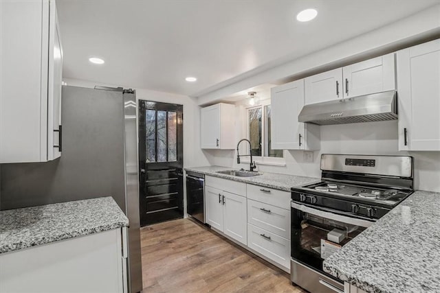 kitchen with white cabinets, light stone counters, sink, and stainless steel appliances