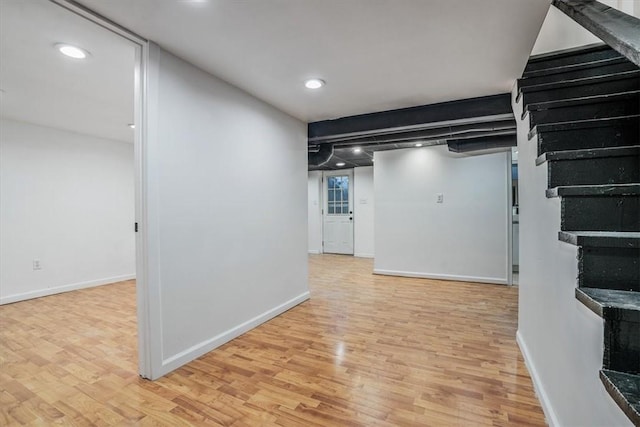 basement with light hardwood / wood-style flooring