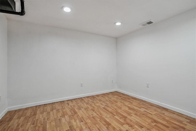 spare room featuring light hardwood / wood-style flooring