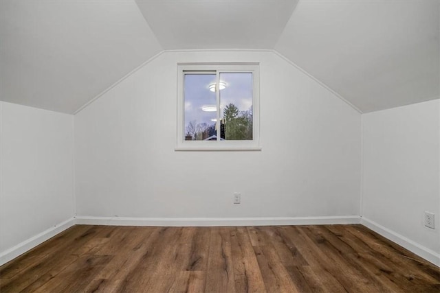 bonus room featuring dark hardwood / wood-style flooring and vaulted ceiling