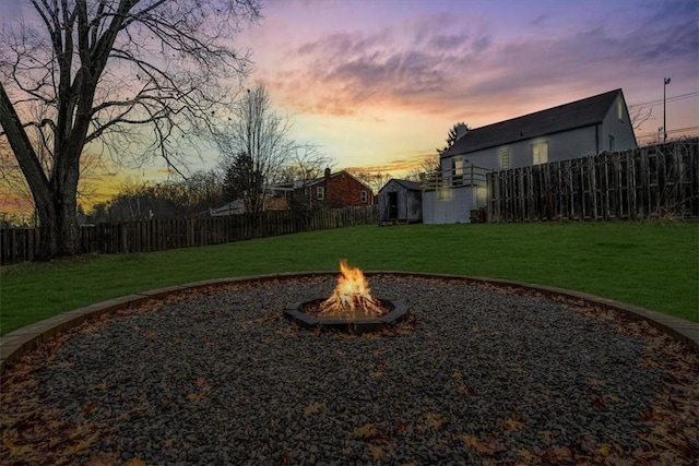 yard at dusk with an outdoor fire pit