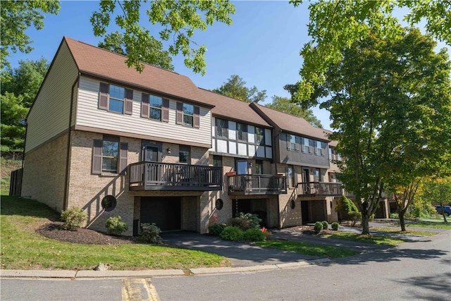 view of property featuring a garage and a wooden deck