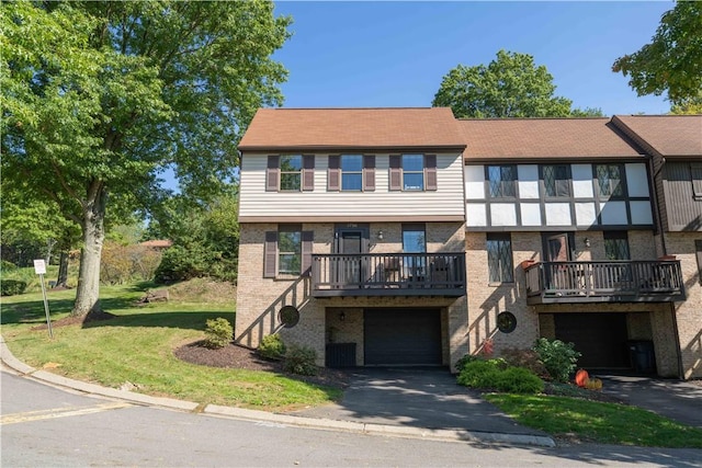 view of property with a garage and a front lawn