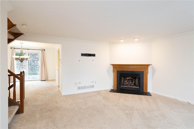 unfurnished living room with an inviting chandelier, light colored carpet, and ornamental molding